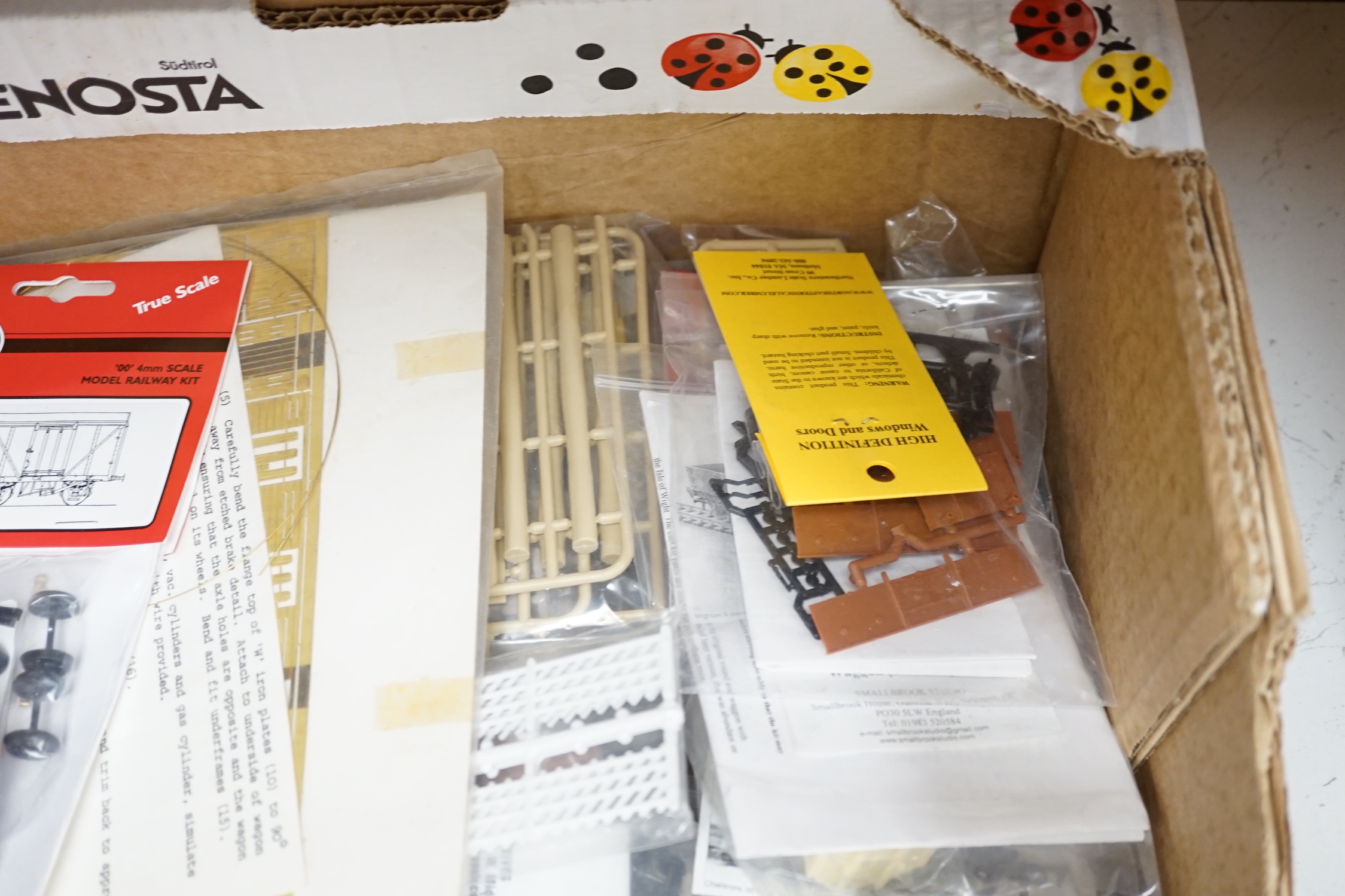 A collection of unmade, 4mm scale 00 gauge model, railway kits, and lineside accessories, including freight wagons, four-wheel coaches, commercial vehicles, etc. by Dapol, Cooper Craft, Parkside Dundas, etc. together wit